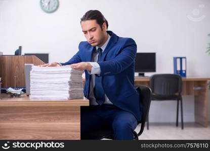 The young handsome businessman working in the office. Young handsome businessman working in the office