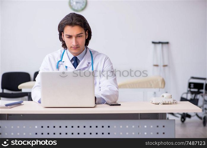 The young handsome doctor in telemedicine concept . Young handsome doctor in telemedicine concept