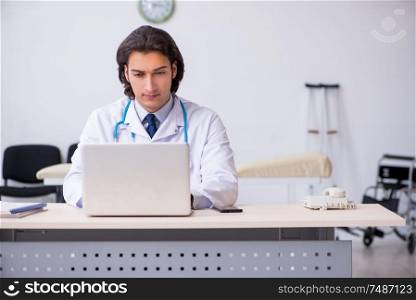 The young handsome doctor in telemedicine concept . Young handsome doctor in telemedicine concept