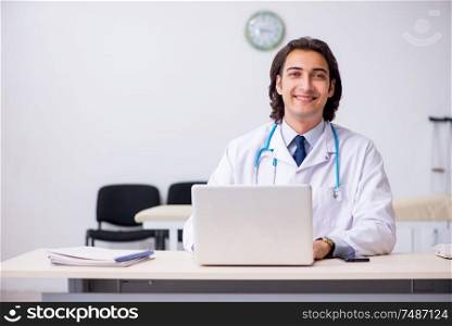 The young handsome doctor in telemedicine concept. Young handsome doctor in telemedicine concept
