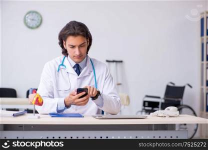 The young handsome doctor in telemedicine concept. Young handsome doctor in telemedicine concept
