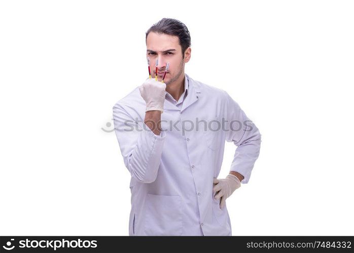 The young handsome doctor with syringe isolated on white . Young handsome doctor with syringe isolated on white