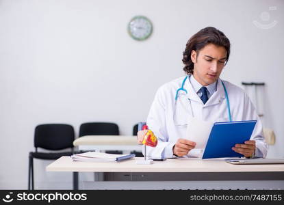 The young handsome doctor working in the clinic. Young handsome doctor working in the clinic