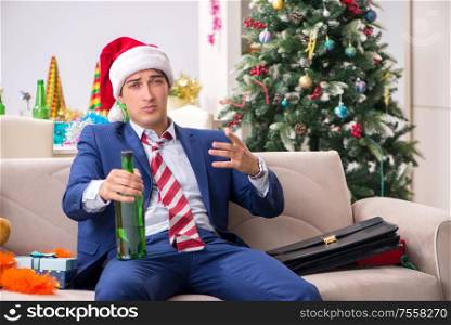 The young handsome employee celebrating christmas at workplace. Young handsome employee celebrating Christmas at workplace