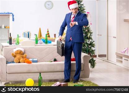 The young handsome employee celebrating christmas at workplace. Young handsome employee celebrating Christmas at workplace