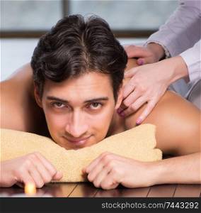 The young handsome man during spa procedure. Young handsome man during spa procedure
