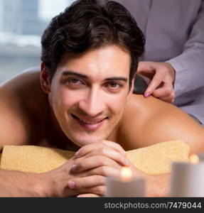 The young handsome man during spa procedure. Young handsome man during spa procedure