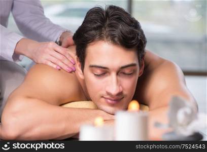 The young handsome man during spa procedure. Young handsome man during spa procedure