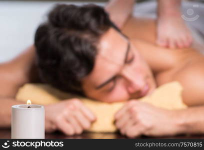 The young handsome man during spa procedure. Young handsome man during spa procedure