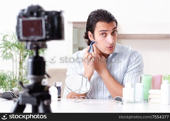 The young handsome man recording his blog in hygiene concept. Young handsome man recording his blog in hygiene concept