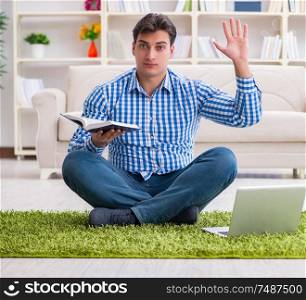 The young handsome man sitting on floor at home. Young handsome man sitting on floor at home