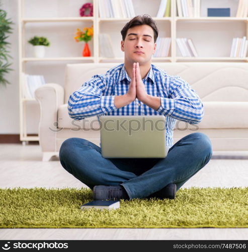 The young handsome man sitting on floor at home. Young handsome man sitting on floor at home