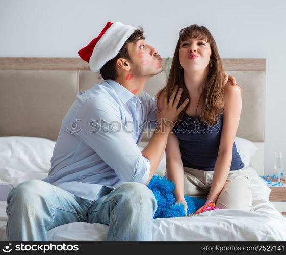 The young happy family celebrating christmas in bed. Young happy family celebrating christmas in bed