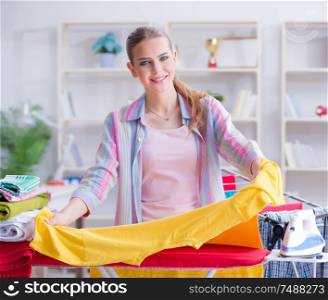 The young housewife doing laundry at home. Young housewife doing laundry at home