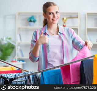 The young housewife doing laundry at home. Young housewife doing laundry at home