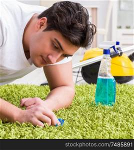 The young husband man cleaning floor at home. Young husband man cleaning floor at home