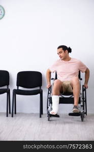 The young injured man waiting for his turn in hospital hall. Young injured man waiting for his turn in hospital hall