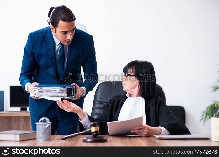 The young intern asking senior judge for advice. Young intern asking senior judge for advice