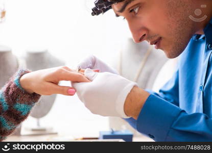 The young jeweler working in his workshop. Young jeweler working in his workshop