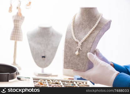 The young jeweler working in his workshop. Young jeweler working in his workshop