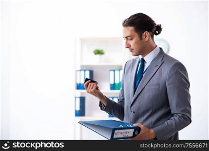 The young male accountant working in the office. Young male accountant working in the office
