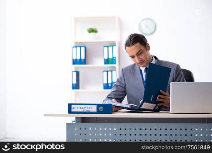 The young male accountant working in the office. Young male accountant working in the office