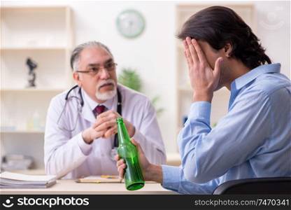The young male alcoholic visiting old doctor  . Young male alcoholic visiting old doctor  