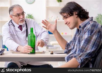 The young male alcoholic visiting old doctor . Young male alcoholic visiting old doctor