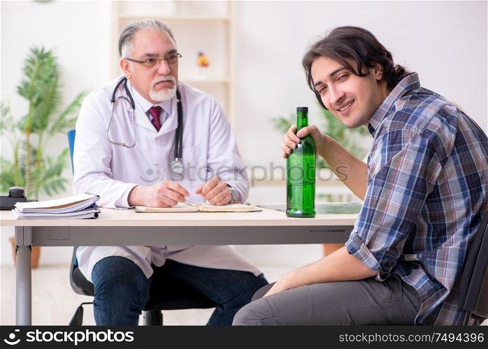 The young male alcoholic visiting old doctor. Young male alcoholic visiting old doctor
