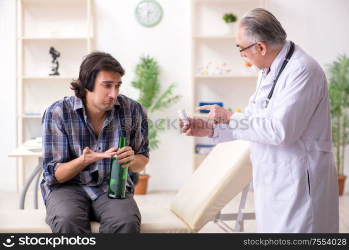 The young male alcoholic visiting old doctor. Young male alcoholic visiting old doctor