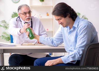 The young male alcoholic visiting old doctor. Young male alcoholic visiting old doctor