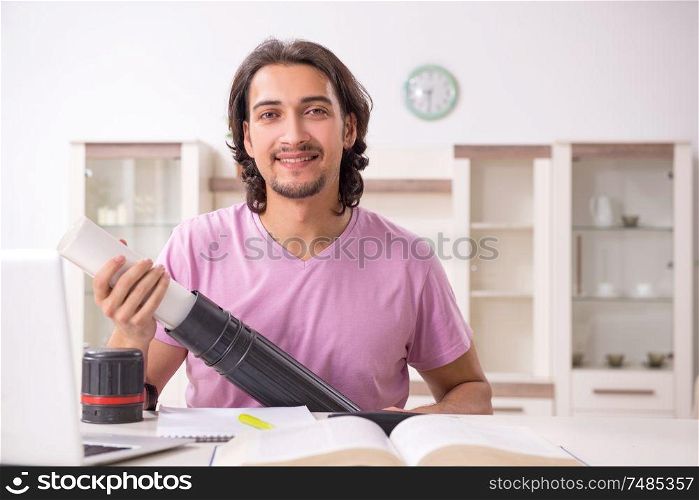 The young male architect student preparing for exams at home. Young male architect student preparing for exams at home