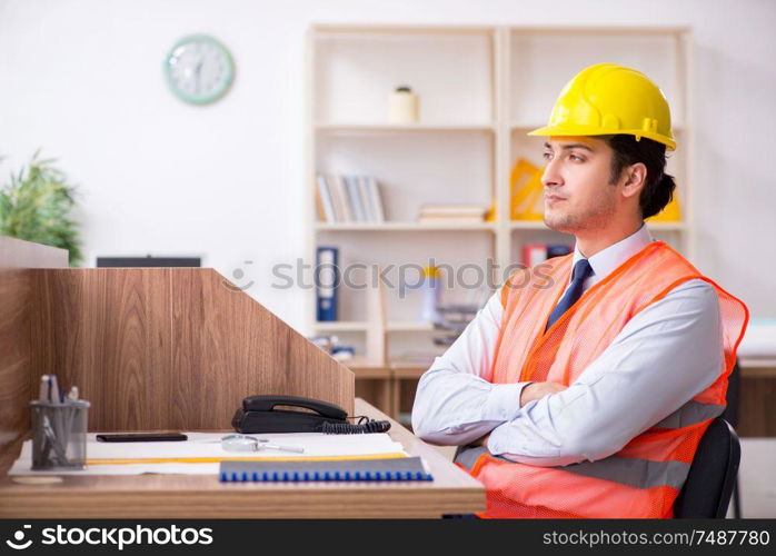 The young male architect working in the office. Young male architect working in the office