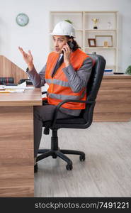 The young male architect working in the office. Young male architect working in the office