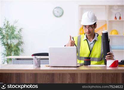 The young male architect working in the office. Young male architect working in the office