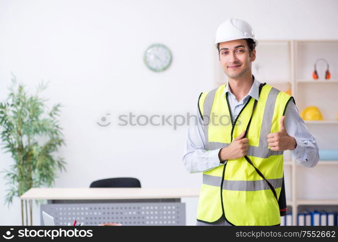 The young male architect working in the office. Young male architect working in the office