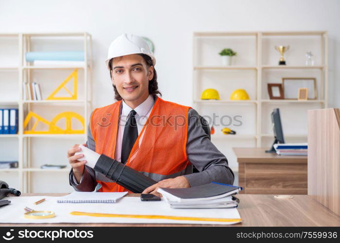 The young male architect working in the office. Young male architect working in the office