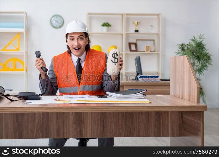 The young male architect working in the office. Young male architect working in the office