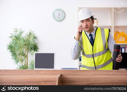 The young male architect working in the office. Young male architect working in the office