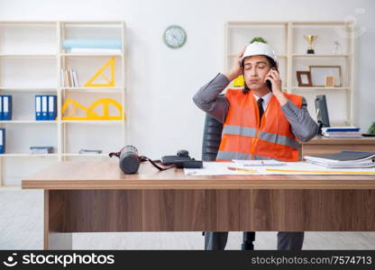 The young male architect working in the office. Young male architect working in the office