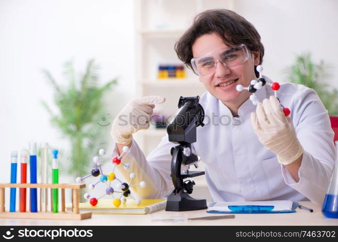 The young male biochemist working in the lab . Young male biochemist working in the lab 