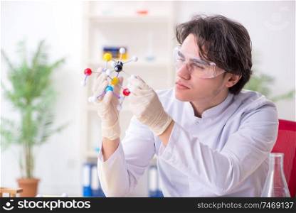 The young male biochemist working in the lab . Young male biochemist working in the lab 