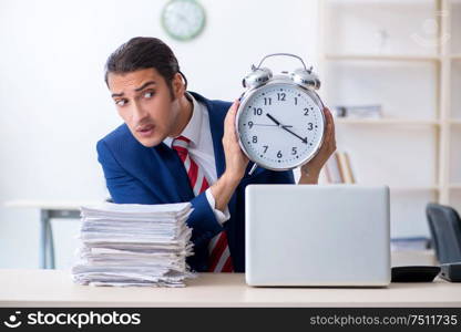 The young male businessman sitting in the office. Young male businessman sitting in the office