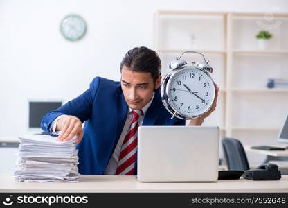 The young male businessman sitting in the office. Young male businessman sitting in the office