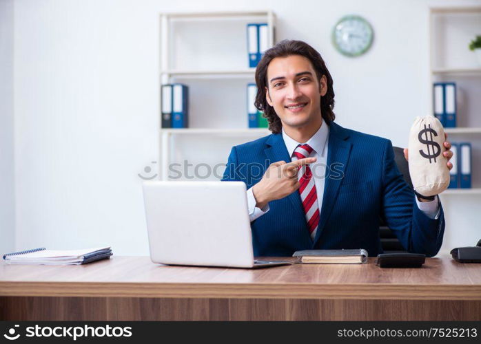 The young male businessman working in the office. Young male businessman working in the office