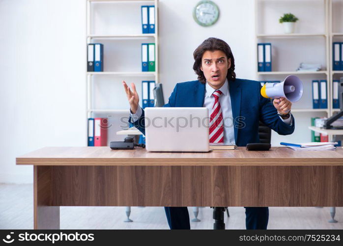 The young male businessman working in the office. Young male businessman working in the office