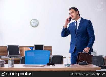 The young male businessman working in the office. Young male businessman working in the office