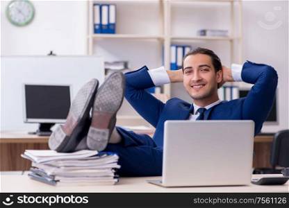 The young male businessman working in the office. Young male businessman working in the office