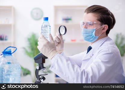 The young male chemist experimenting in lab. Young male chemist experimenting in lab