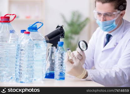 The young male chemist experimenting in lab. Young male chemist experimenting in lab